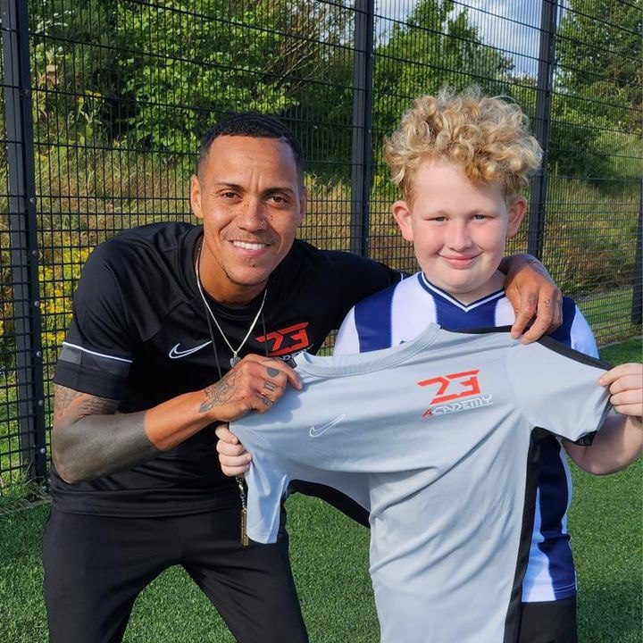 Kyle and one of the players receiving their jersey